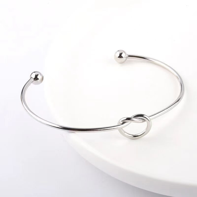 Layered Knot Cuff Bracelets: A Symphony of Shimmer