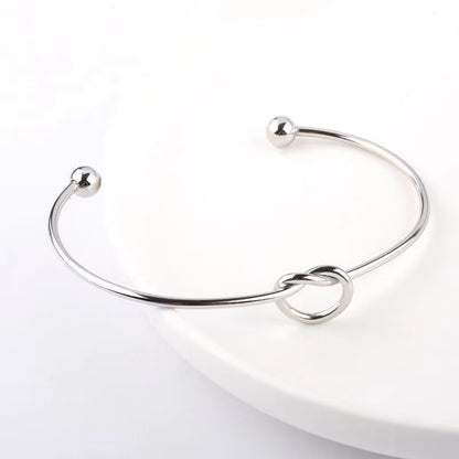 Layered Knot Cuff Bracelets: A Symphony of Shimmer